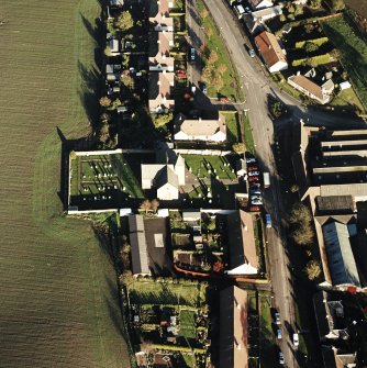 Oblique aerial view of the Carrington Parish Church centred on the church with a general view of burgh, village, taken from the W.