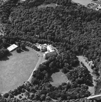 Oblique aerial view centred on the country house and garden with bridge adjacent, taken from the NE.