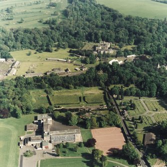 Oblique aerial view of Newbattle Abbey, garden, sundials and military camp, taken from the NE.