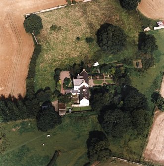 Oblique aerial view centred on the country house with garden adjacent, taken from the SW.