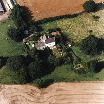 Oblique aerial view centred on the country house with garden adjacent, taken from the SSE.