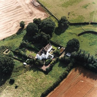 Oblique aerial view centred on the country house with garden adjacent, taken from the NNE.