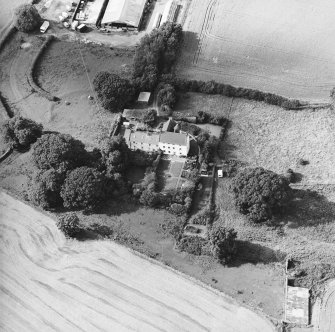 Oblique aerial view centred on the country house with garden adjacent, taken from the SE.