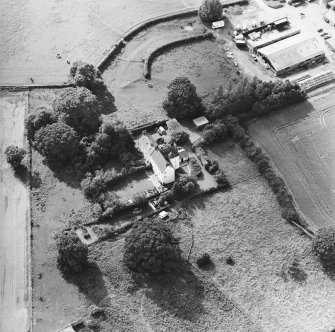 Oblique aerial view centred on the country house with garden adjacent, taken from the ENE.