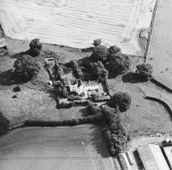 Oblique aerial view centred on the country house with garden adjacent, taken from the NW.