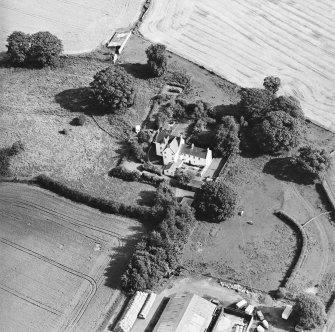 Oblique aerial view centred on the country house with garden adjacent, taken from the WNW.