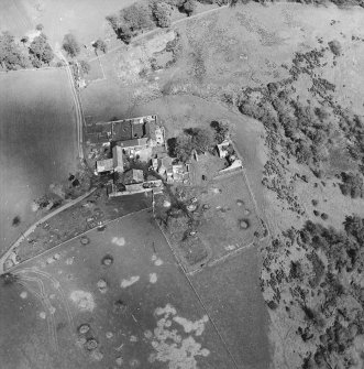 Oblique aerial view centred on the remains of the castle with the remains of the fish ponds, farmhouse and farmsteading adjacent, taken from the WSW.