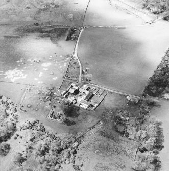 Oblique aerial view centred on the remains of the castle with the remains of the fish ponds, farmhouse and farmsteading adjacent, taken from the SE.