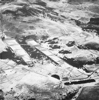 General oblique aerial view centred on the rifle range with the remains of the fort, trenches and rig adjacent, taken from the SSW.