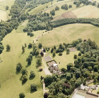 Oxenfoord Castle: oblique aerial view, taken from the NE, centred on cropmarks of a possible formal garden and linear cropmarks. Oxenfoord Castle is also visible in the centre of the photograph.