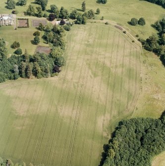 Oxenfoord Castle: oblique aerial view, taken from the NW, centred on cropmarks of a possible formal garden and linear cropmarks. Oxenfoord Castle is also visible in the top left hand corner of the photograph.