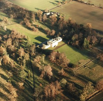 Preston Hall, oblique aerial view, taken from the SW, centred on the country house with the stables in the top centre of the photograph.