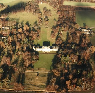 Preston Hall, oblique aerial view, taken from the S, centred on the country house with the stables and formal gardens on either side.