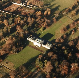 Oblique aerial view, taken from the SW, centred on the country house with the formal garden in the top left-hand corner of the photograph.
