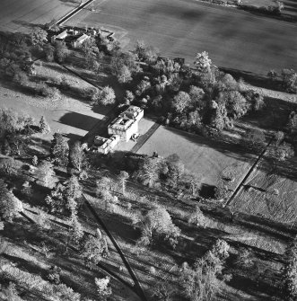 Preston Hall, oblique aerial view, taken from the SW, centred on the country house with the stables in the top left-hand corner of the photograph.