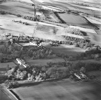 Preston Hall, oblique aerial view, taken from the ESE, centred on the country house with the stables and formal gardens on either side.