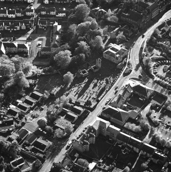 Oblique aerial view of Penicuik, ST Kentigern's Church and Churchyard centred on a church, churchyard and burial ground, with a mausoleum and other church and hearse house adjacent, taken from the N.