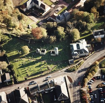 Oblique aerial view of Penicuik, ST Kentigern's Church and Churchyard centred on the church, churchyard and burial ground, with an adjacent mausoleum and church and hearse house, taken from the N.