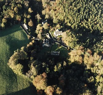 Oblique aerial view of the Temple Parish Church centred on the church with other church, possible building, culvert and other building adjacent, taken from the S.