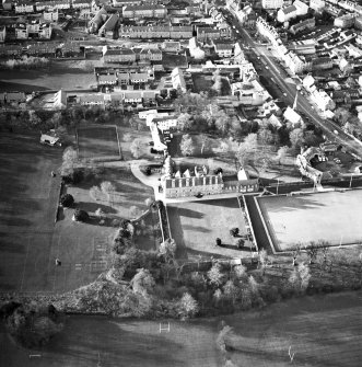 Oblique aerial view centred on the tower-house, school and garden, taken from the E.