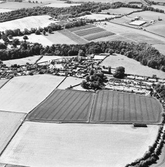 Oblique aerial view centred on the village with farmhouse adjacent, taken from the ESE.