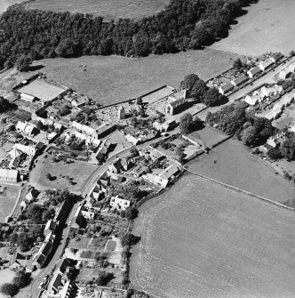 Oblique aerial view centred on the church, burial ground, old church, mausoleum and village, taken from the SSW.