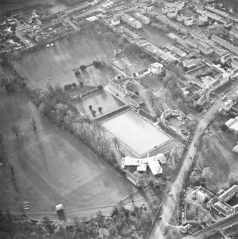 Oblique aerial view centred on the tower-house, school and garden, taken from the NE.