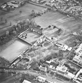 Oblique aerial view centred on the tower-house, school and garden, taken from the NW.