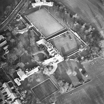 Oblique aerial view centred on the tower-house, school and garden, taken from the SW.