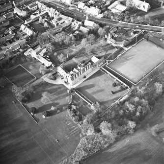 Oblique aerial view centred on the tower-house, school and garden, taken from the SE.