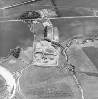 Oblique aerial view centred on the quarry with the farmhouse adjacent, taken from the NNE.