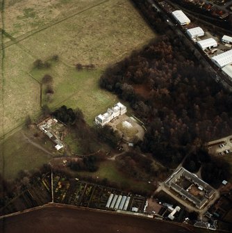 Oblique aerial view centred on the country house with walled garden, stables, cottage, formal garden and dovecot adjacent, taken from the W.