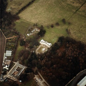 Oblique aerial view centred on the country house with walled garden, stables, cottage, formal garden and dovecot adjacent, taken from the SW.