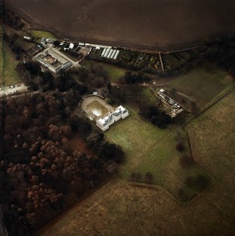 Oblique aerial view centred on the country house with walled garden, stables, cottage, formal garden and dovecot adjacent, taken from the ESE.