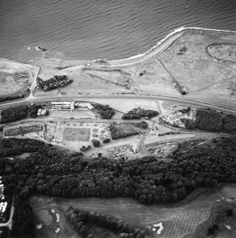 Oblique aerial view centred on the museum and remains of the coal mine, brick-works, tile-works and harbour, taken from the SSE.