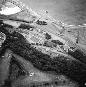 Oblique aerial view centred on the museum and remains of the coal mine, brick-works, tile-works and harbour, taken from the SE.