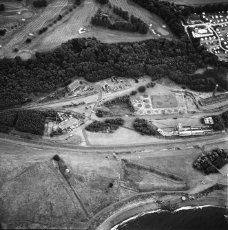 Oblique aerial view centred on the museum and remains of the coal mine, brick-works, tile-works and harbour, taken from the NNW.