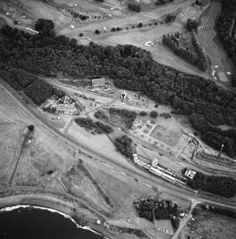 Oblique aerial view centred on the museum and remains of the coal mine, brick-works, tile-works and harbour, taken from the NW.