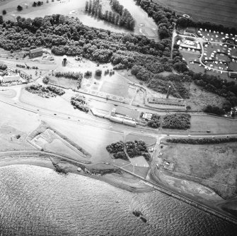 Oblique aerial view centred on the museum and the remains of the coal mine, brick and tileworks and harbour, taken from the NW.
