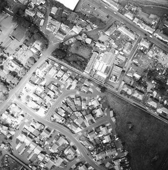 Oblique aerial view centred on the house and stables, taken from the ESE.