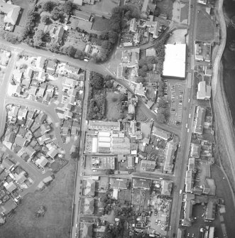 Oblique aerial view centred on the house and stables, taken from the NE.