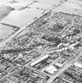 Oblique aerial view of Broxburn centred on the town housing development designed by Wheeler and Sproson in 1968-70, and recorded as part of the Wheeler and Sproson Project, with Broxburn parish church adjacent.  Taken from the NE.