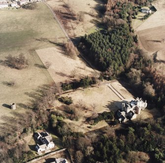 Oblique aerial view taken from the SW, centred on Wallhouse and a dovecot.