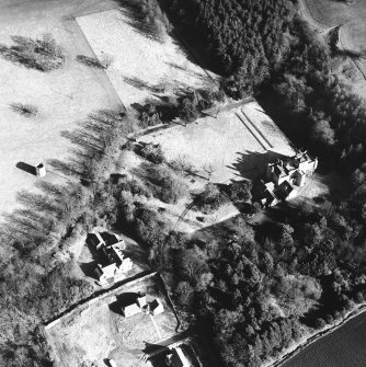 Oblique aerial view, taken from the W, centred on the country house. A dovecot is visible in the centre left of the photograph.