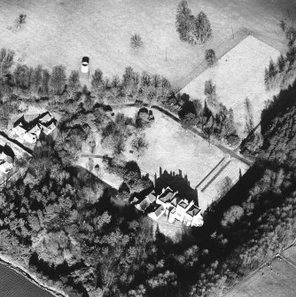 Oblique aerial view, taken from the SW, centred on the country house. A dovecot is visible in the top right-hand corner of the photograph.