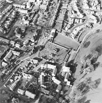 Oblique aerial view centred on the remains of the burial enclosures and village, taken from the SW.