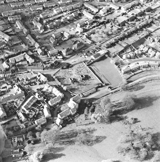 Oblique aerial view centred on the remains of the burial enclosures and village, taken from the S.