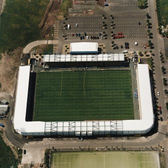 Oblique aerial view centred on the football stadium, taken from the E.