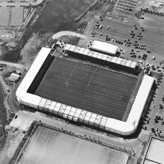 Oblique aerial view centred on the football stadium, taken from the ENE.