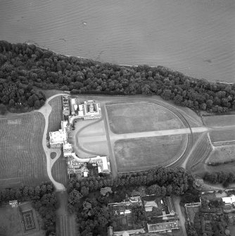 Oblique aerial view centred on the house, taken from the S.